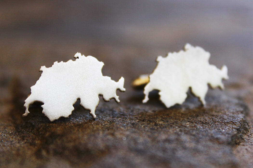 Map cufflinks shown in sterling silver with matte finish and Switzerland border.