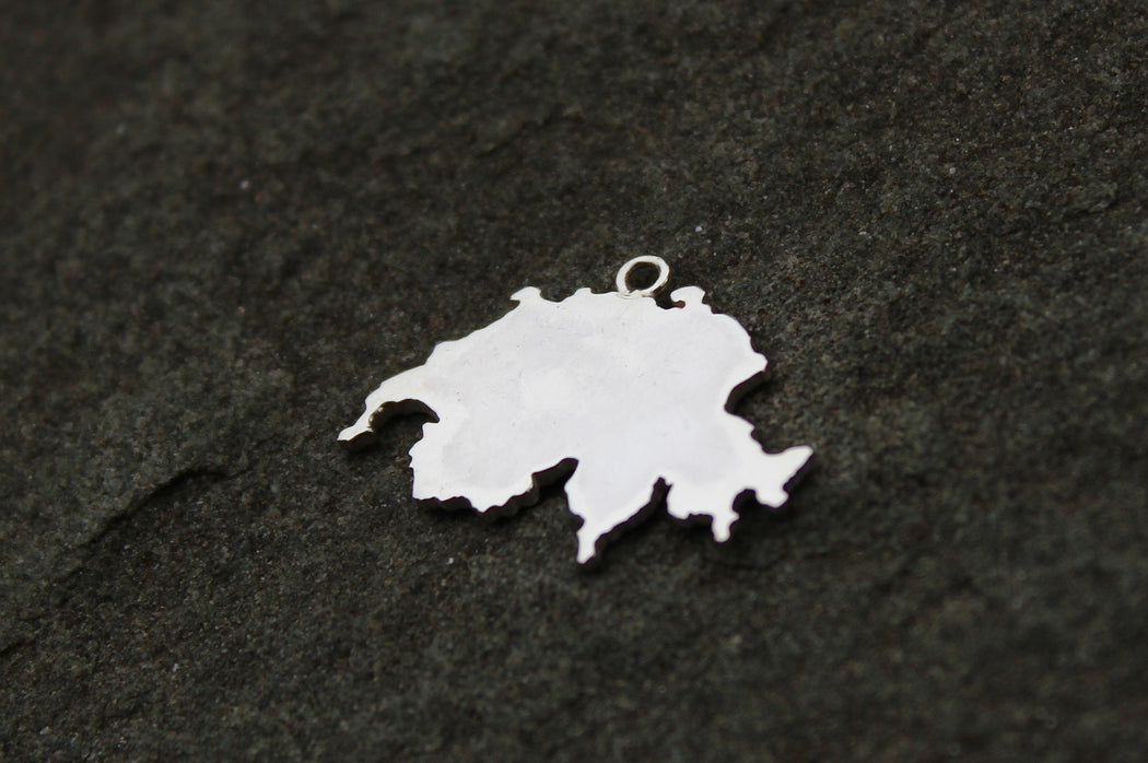 Silhouette-style charm in sterling silver with polished finish, shown with Switzerland border.