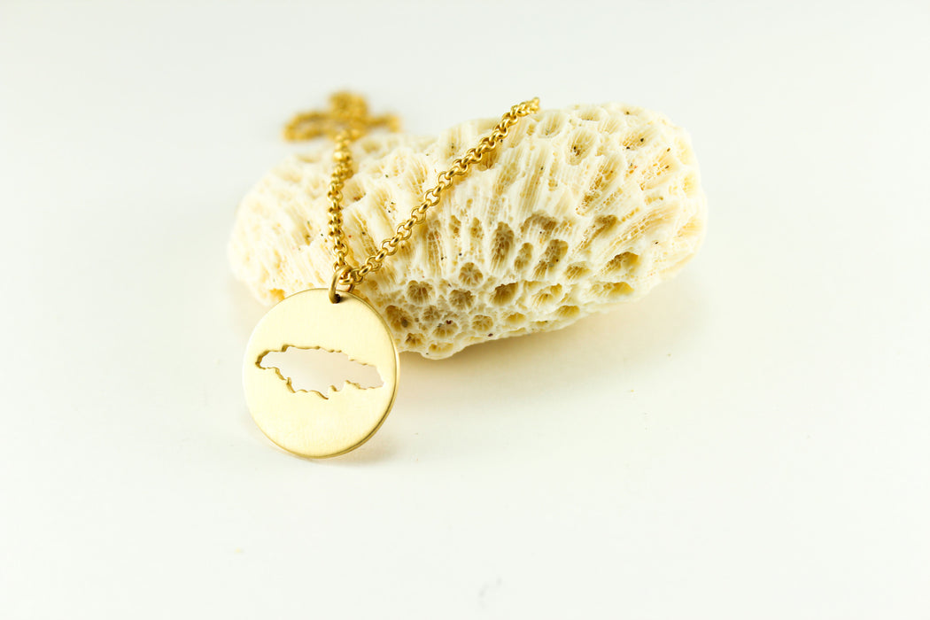 Large medallion necklace shown in brass with matte finish, 18" ball chain and Jamaica border.
